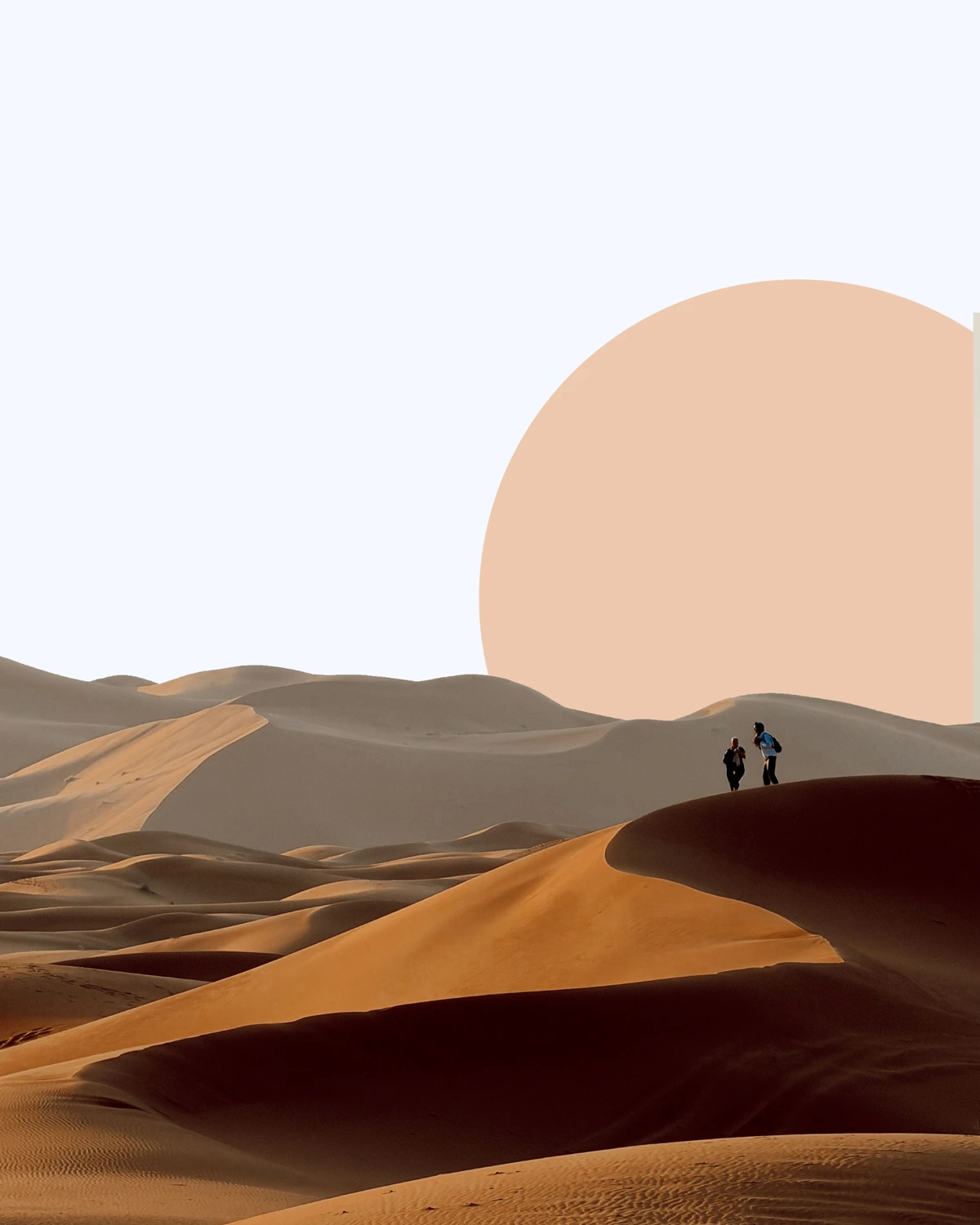 Desert dunes at dusk with a warm peach sun and two figures on a ridge