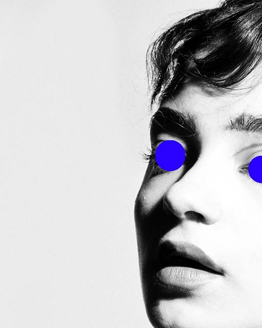 Black-and-white close-up portrait with bright blue circles over the eyes